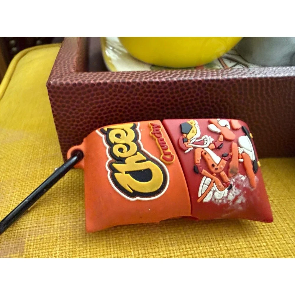 AirPods charger and half of a Cheetos case